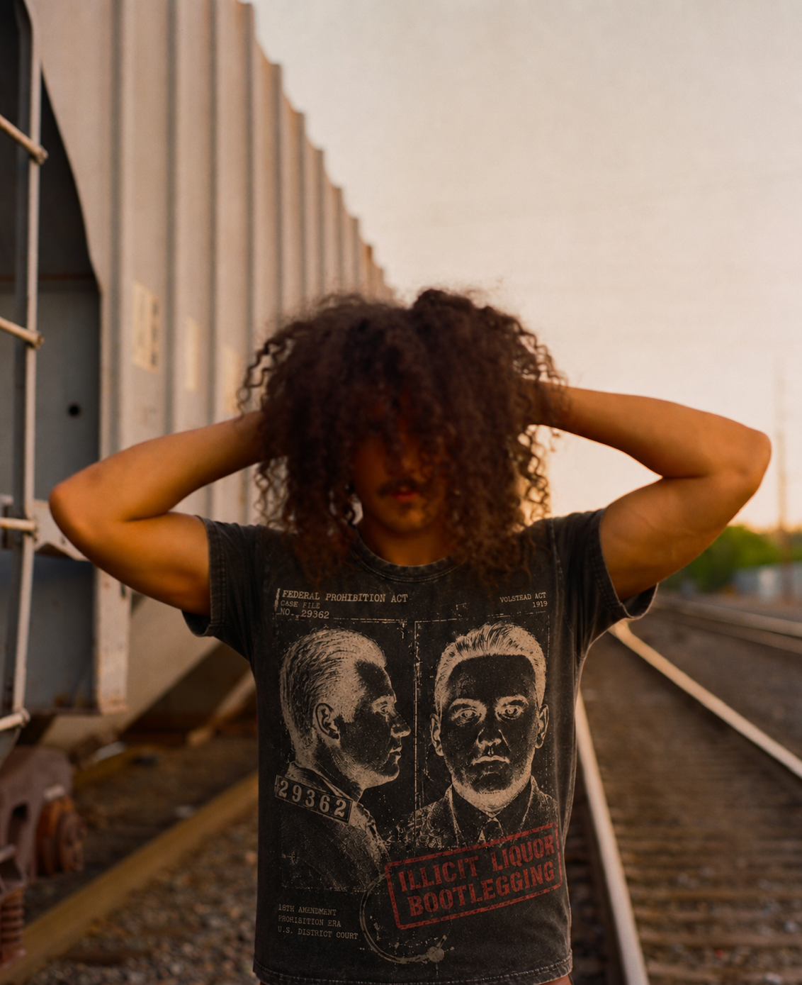 The case tee on a body, the file print across the chest: two faces, number 29362, the red stamp